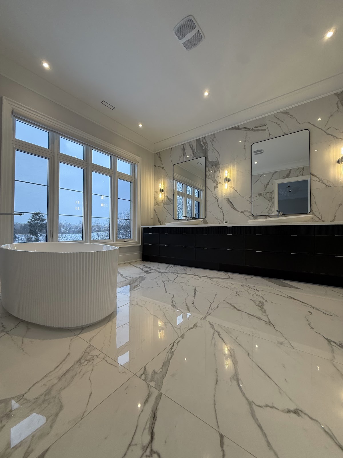 Spotless marble bathroom with freestanding tub after a deep clean