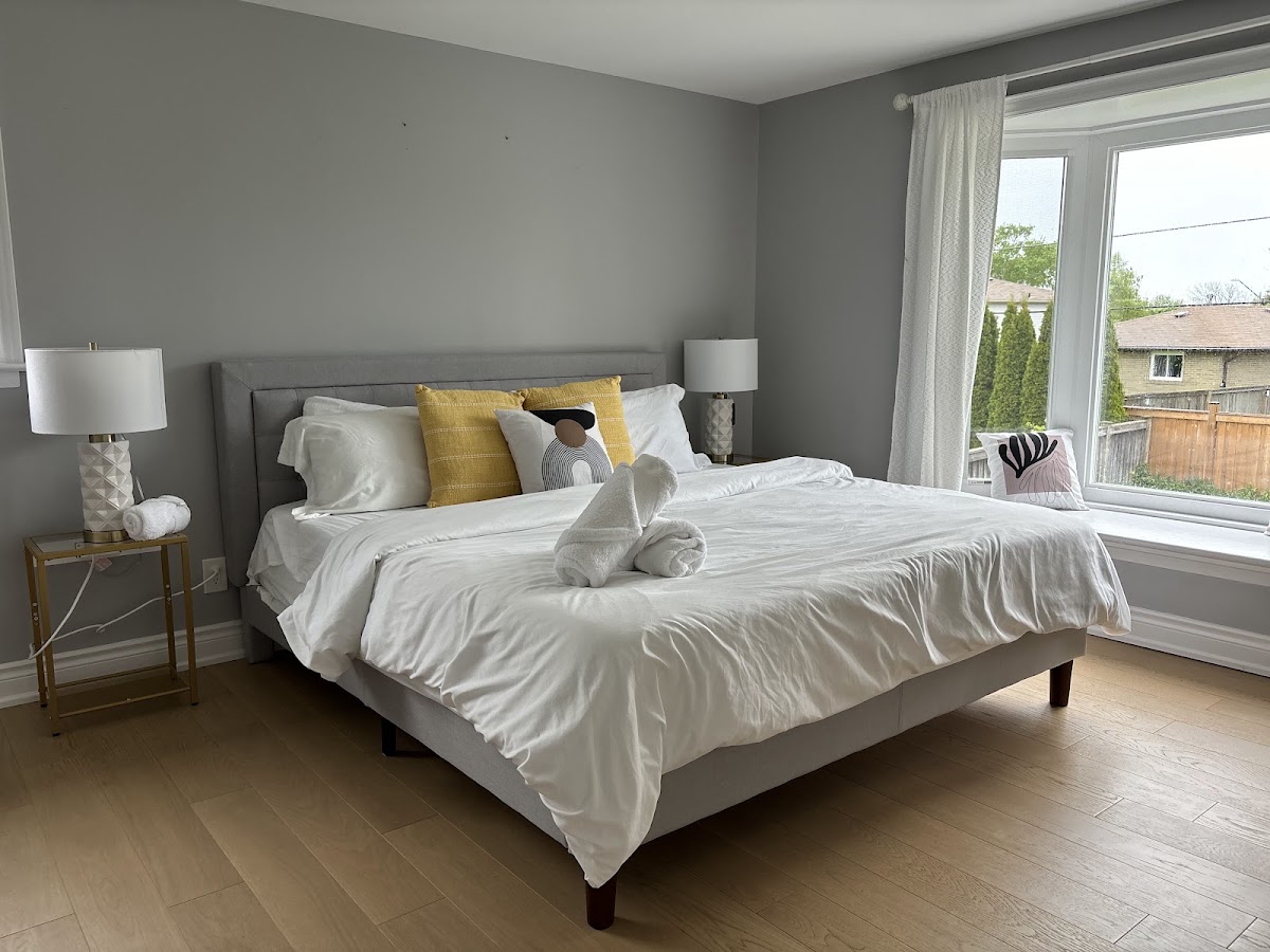 Bedroom made up hotel-style with rolled towels after a Queen Maid clean